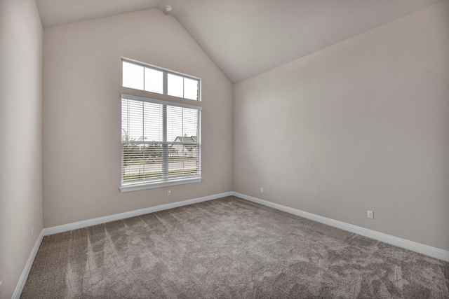 carpeted empty room with lofted ceiling