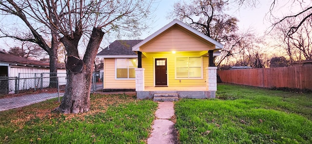 bungalow-style house featuring a yard