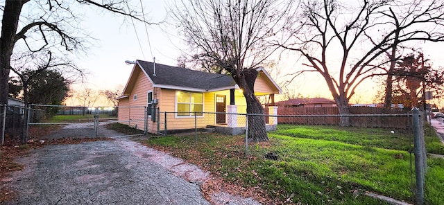 property exterior at dusk featuring a yard