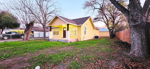 view of side of property featuring a yard and central air condition unit