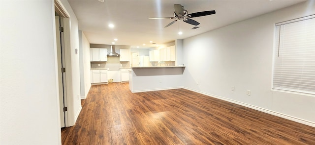 unfurnished living room with ceiling fan and dark wood-type flooring