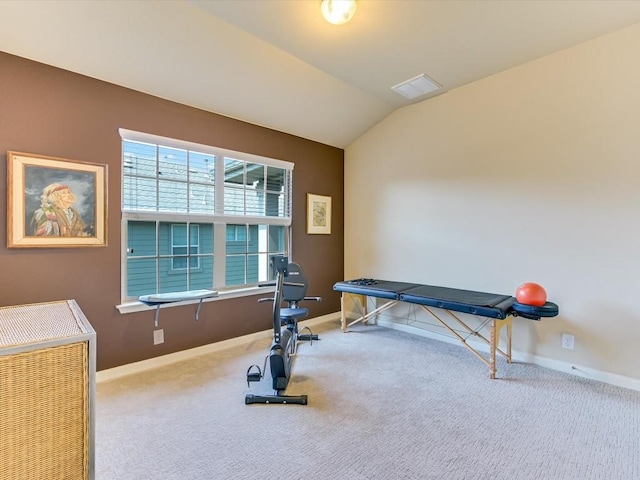 exercise area with vaulted ceiling and carpet