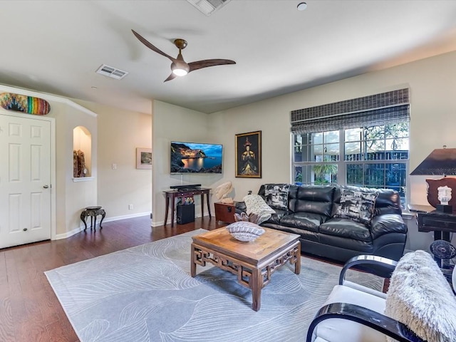 living room with ceiling fan and dark hardwood / wood-style flooring