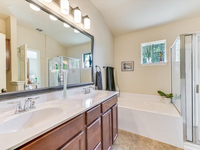 bathroom featuring tile patterned flooring, vanity, a wealth of natural light, and independent shower and bath