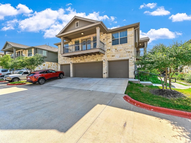 view of front of house featuring a garage and a balcony