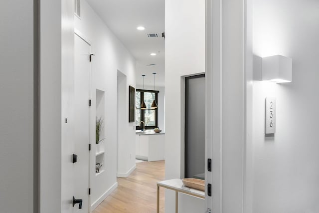 hallway featuring light hardwood / wood-style flooring