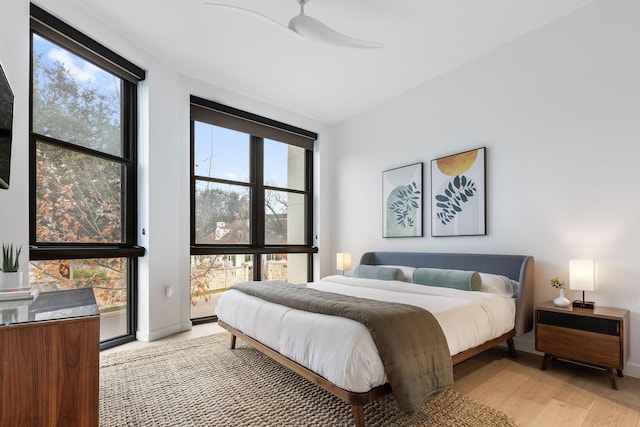 bedroom with ceiling fan and light wood-type flooring