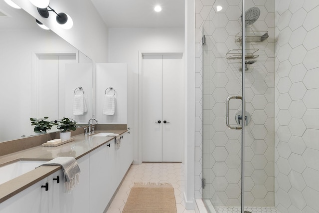 bathroom with walk in shower, vanity, and tile patterned flooring