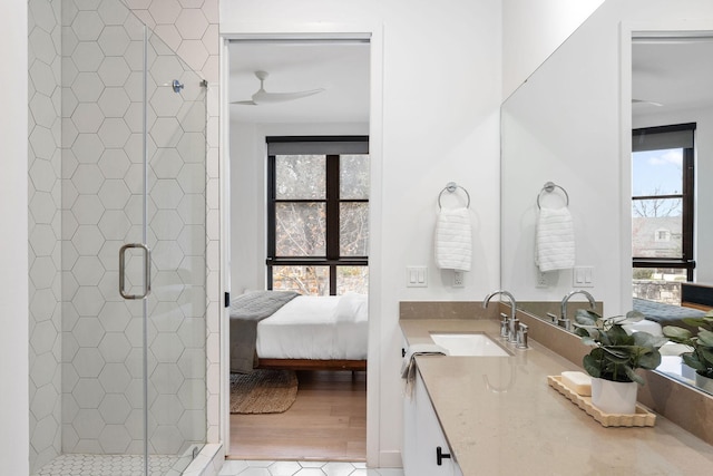 bathroom featuring ceiling fan, vanity, tile patterned flooring, and a shower with door