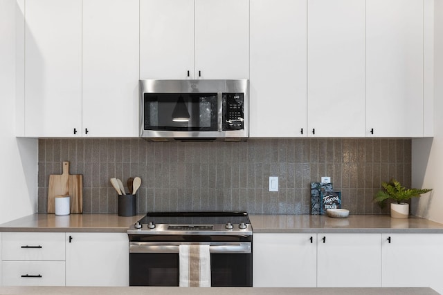 kitchen with white cabinets and appliances with stainless steel finishes