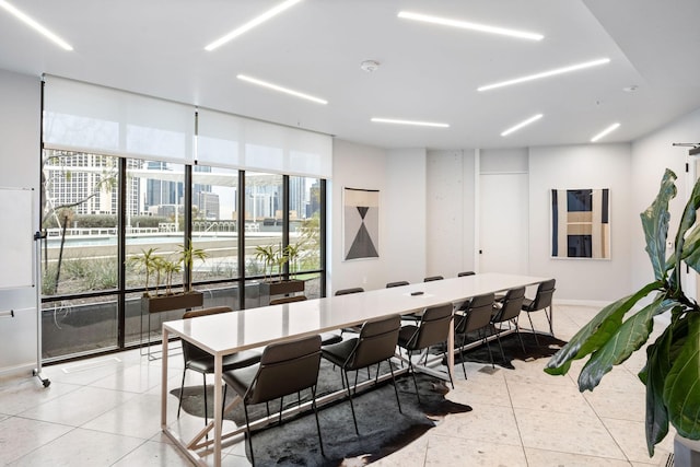 tiled dining area with a healthy amount of sunlight and floor to ceiling windows