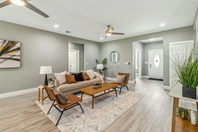 living room with ceiling fan and light wood-type flooring