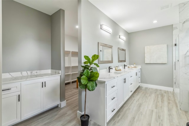 bathroom featuring hardwood / wood-style flooring, an enclosed shower, and vanity