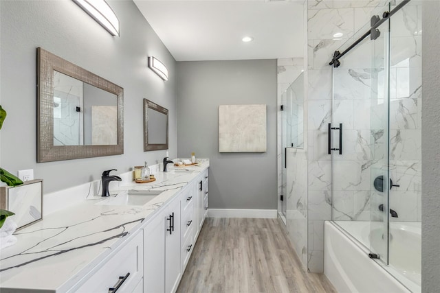 bathroom with combined bath / shower with glass door, vanity, and hardwood / wood-style flooring