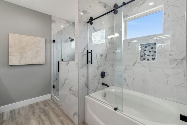 bathroom featuring bath / shower combo with glass door and hardwood / wood-style floors