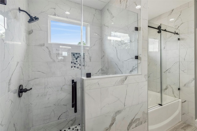 bathroom featuring bath / shower combo with glass door