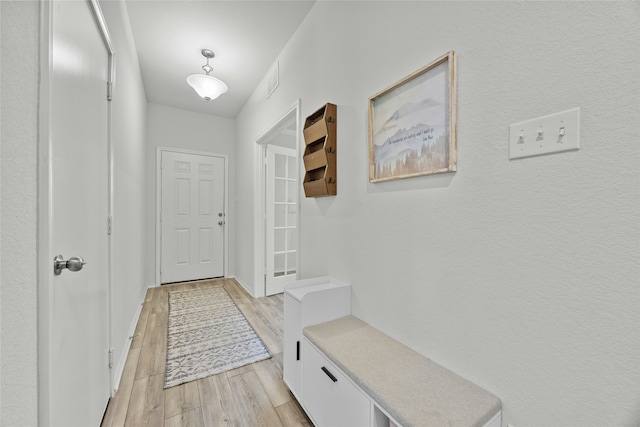 hallway with light hardwood / wood-style floors