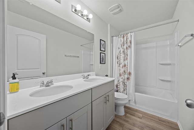 full bathroom with toilet, vanity, shower / bath combination with curtain, and hardwood / wood-style flooring