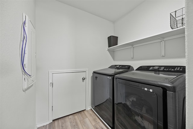 laundry area featuring separate washer and dryer and light wood-type flooring