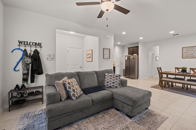 living room featuring ceiling fan and light tile patterned flooring