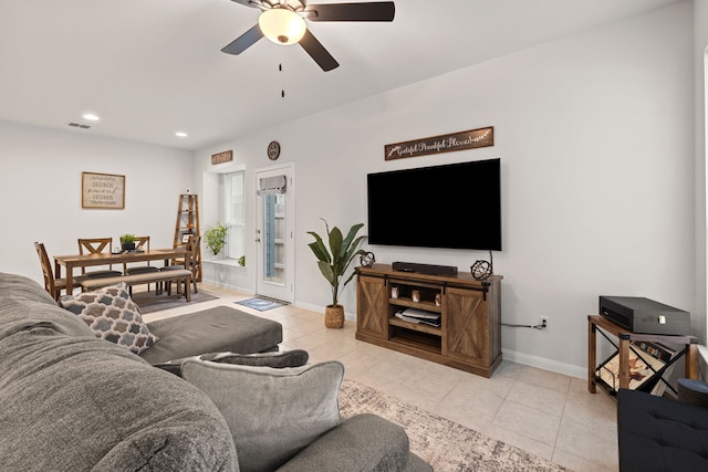 tiled living room with ceiling fan