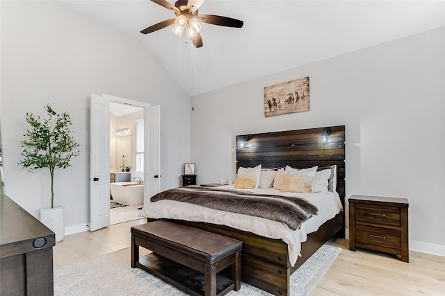 bedroom with light wood-type flooring, ceiling fan, ensuite bathroom, and lofted ceiling