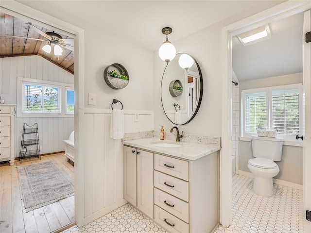 bathroom featuring toilet, wood ceiling, ceiling fan, vaulted ceiling, and vanity