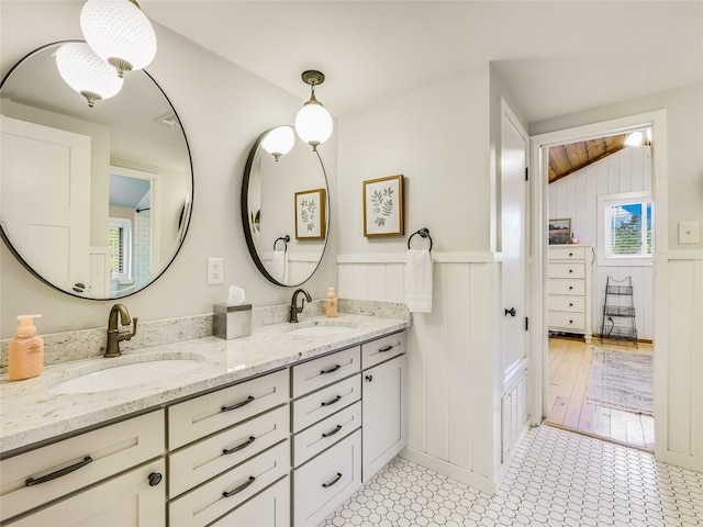 bathroom featuring vaulted ceiling and vanity