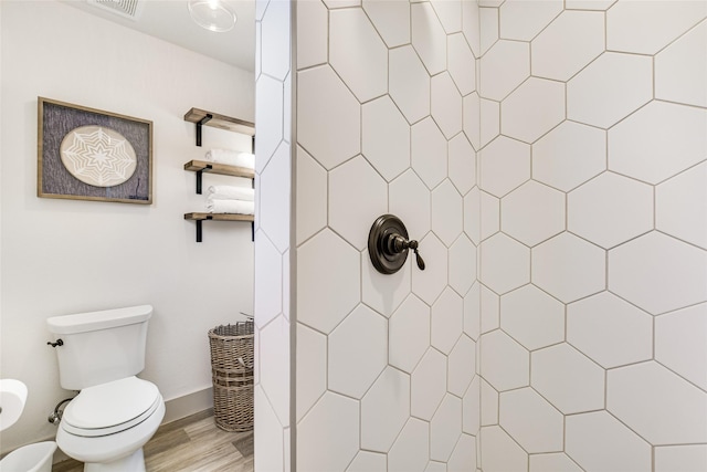 bathroom with toilet, wood-type flooring, and walk in shower