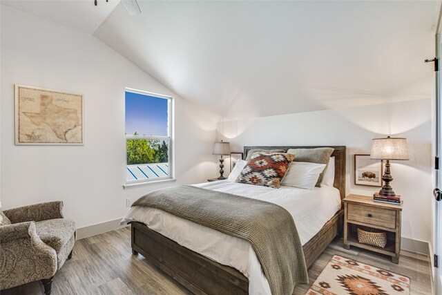 bedroom featuring vaulted ceiling, ceiling fan, and hardwood / wood-style floors