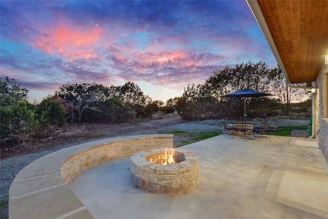 patio terrace at dusk with an outdoor fire pit