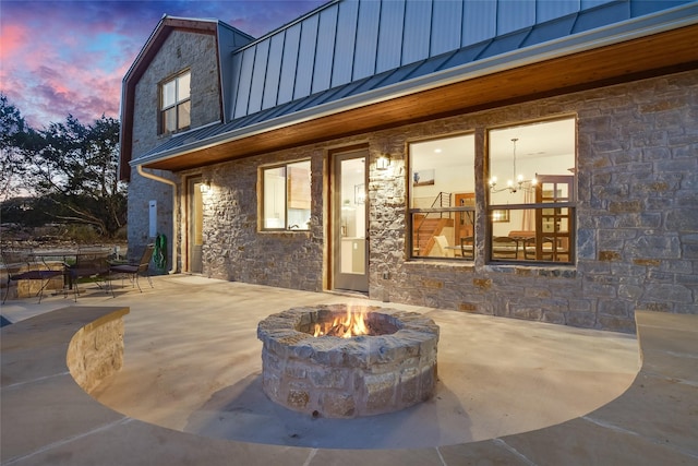 exterior entry at dusk with a patio