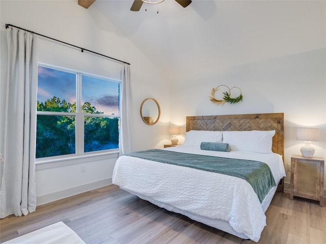 bedroom featuring hardwood / wood-style flooring, high vaulted ceiling, and ceiling fan