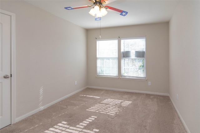 carpeted spare room with ceiling fan