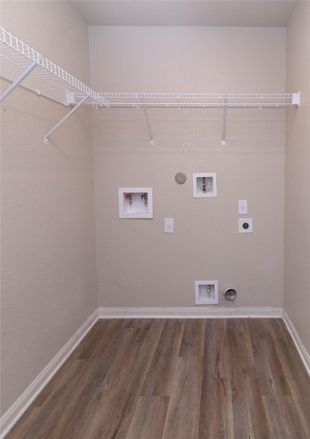 clothes washing area with gas dryer hookup, dark hardwood / wood-style floors, washer hookup, and electric dryer hookup