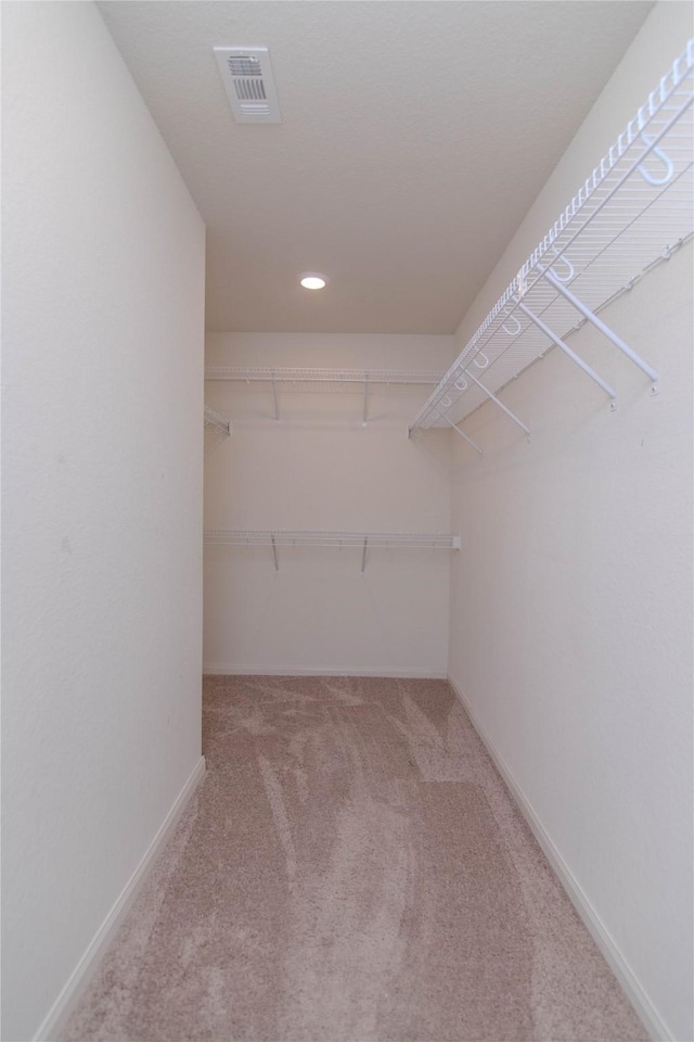 walk in closet with carpet flooring