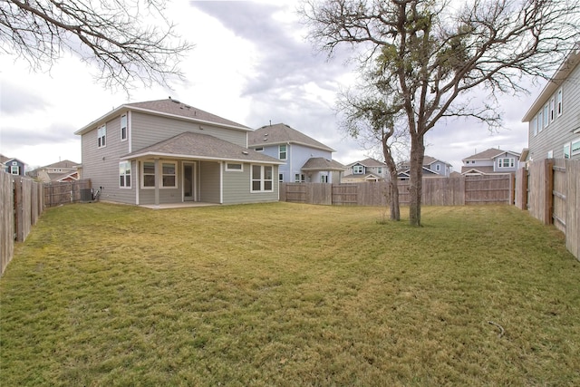 rear view of house with a patio area and a yard