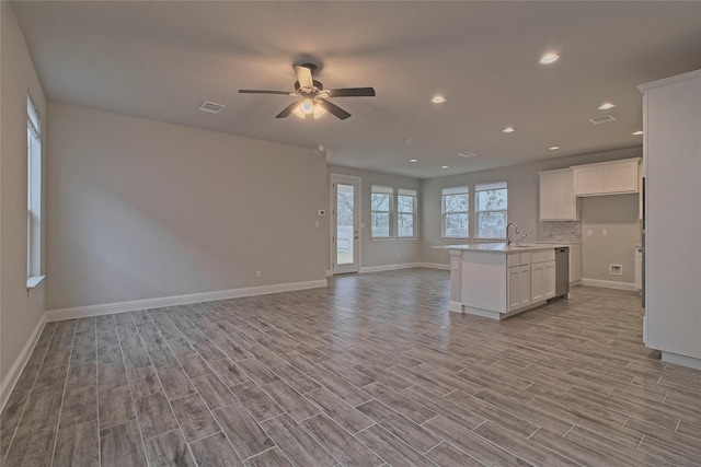 unfurnished living room featuring light hardwood / wood-style floors, a wealth of natural light, and ceiling fan