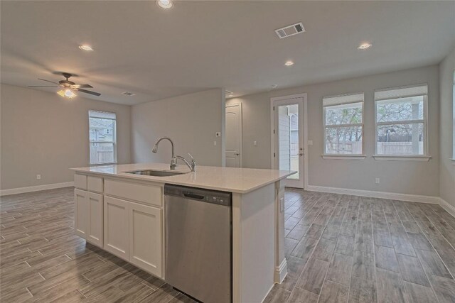 kitchen featuring white cabinets, dishwasher, an island with sink, sink, and ceiling fan