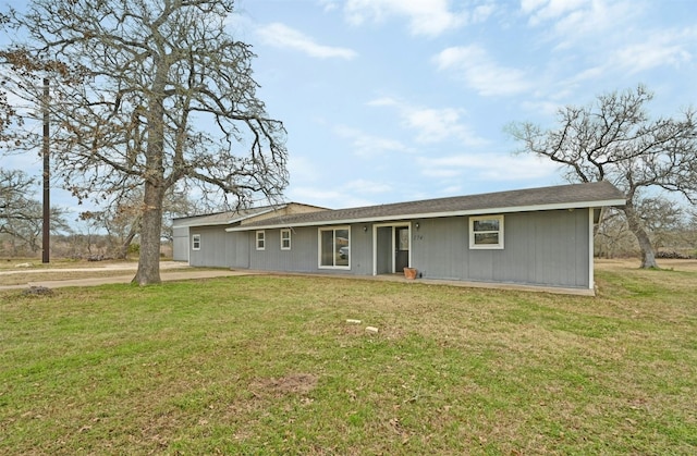 back of property with a yard
