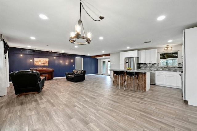 kitchen featuring appliances with stainless steel finishes, a center island, recessed lighting, and open floor plan