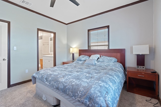 carpeted bedroom featuring ceiling fan, crown molding, and ensuite bath