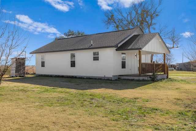 rear view of property with a lawn