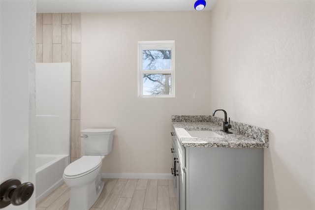 bathroom with toilet, hardwood / wood-style flooring, and vanity