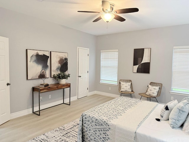 bedroom with ceiling fan and light hardwood / wood-style flooring