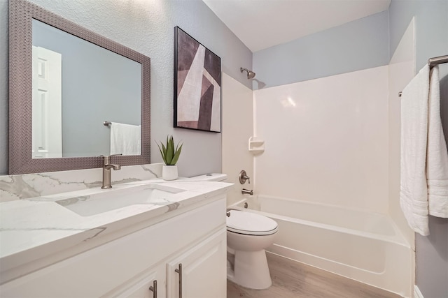 full bathroom featuring toilet, shower / bath combination, hardwood / wood-style floors, and vanity