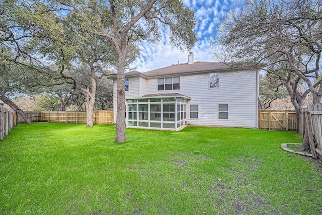 back of house with a sunroom and a lawn