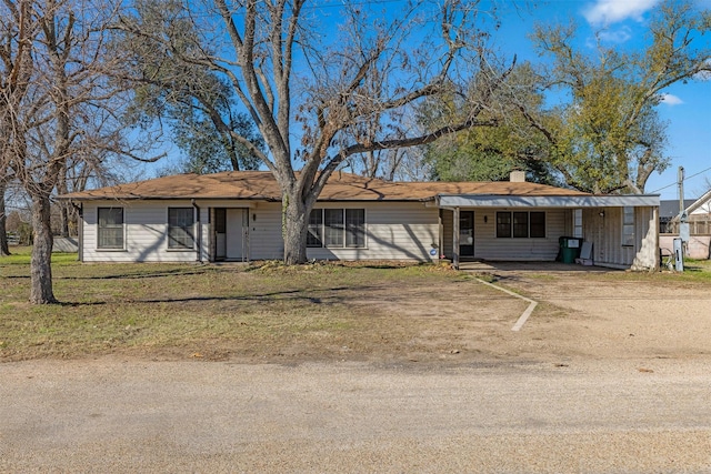 ranch-style home with a front lawn