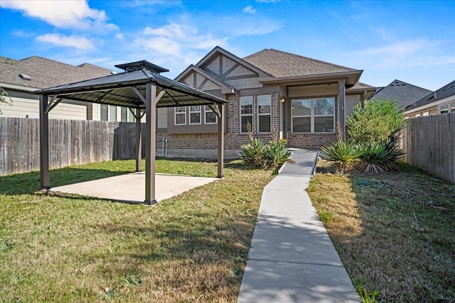 exterior space with a patio area, a gazebo, and a yard