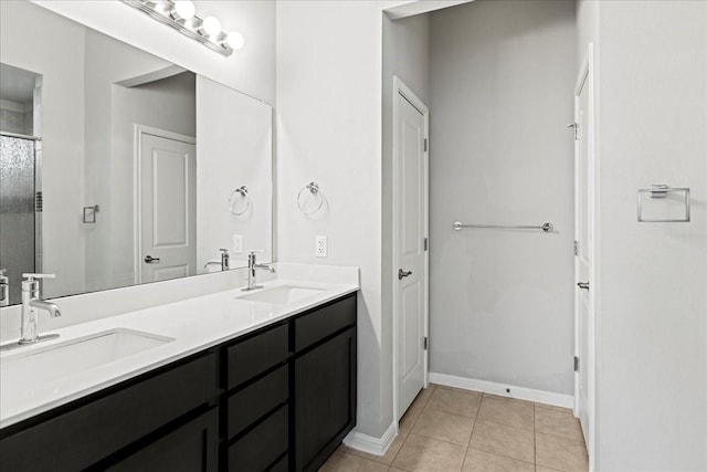 bathroom featuring a shower with door, tile patterned floors, and vanity